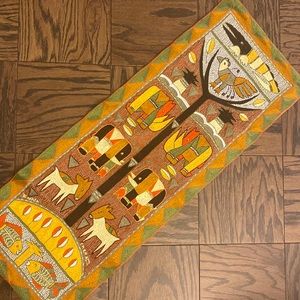 Kaross African tapestry. Can convert to a table runner as poles are removable